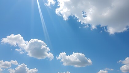 Clear blue sky filled with soft, fluffy white clouds floating gently, creating a bright and peaceful atmosphere on a sunny day with natural daylight