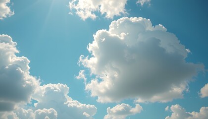 Clear blue sky filled with soft, fluffy white clouds floating gently, creating a bright and peaceful atmosphere on a sunny day with natural daylight