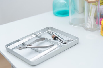Podiatry instruments resting on sterile tray in clinic setting