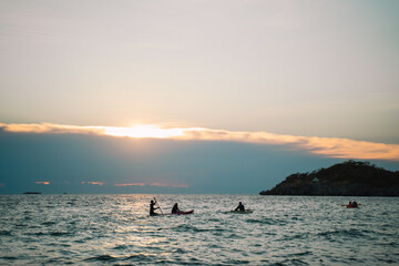 The island glowed beneath the summer sky as the sun set over the ocean, painting the seascape in...