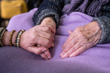 Elderly Woman Holding Hands With Daughter, Receiving Support And Compassionate Care In Nursing...