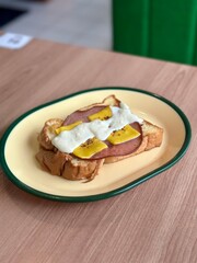 Toast with ham and cheese topped with creamy carbonara sauce—rich, savory, and indulgent, perfect for a comforting meal. April 6. 2025 - Cisauk, Indonesia.
