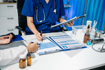 Doctors and nurses review medical paperwork and prescriptions in a professional healthcare setting....