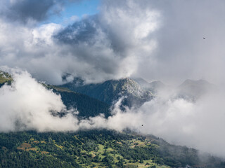 Misty mountain landscape with dramatic clouds, French Alps