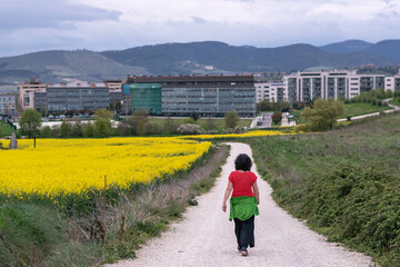 Fototapeta premium Woman walks home through fields. Sarriguren, Navarra