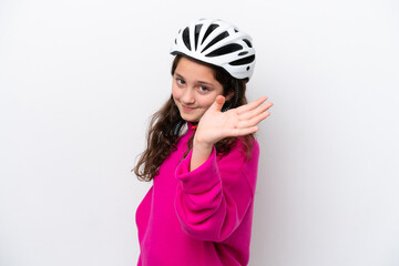 Little cyclist girl isolated on white background saluting with hand with happy expression