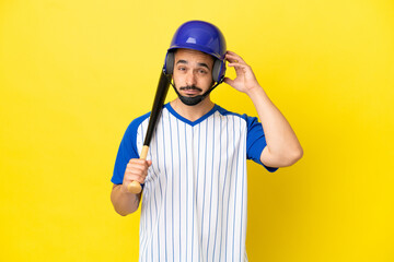 Young caucasian man playing baseball isolated on yellow background having doubts