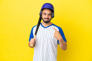 Young caucasian man playing baseball isolated on yellow background giving a thumbs up gesture