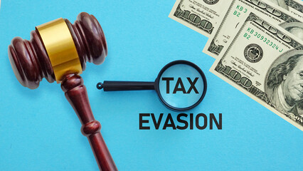 Dollars, court gavel and magnifying glass. Anti money laundering AML and tax evasion