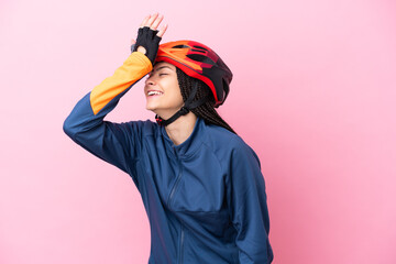 Teenager cyclist girl isolated on pink background has realized something and intending the solution