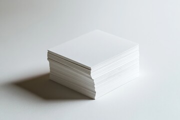 A stack of blank white square cards sits on a white surface, ready for printing and design.