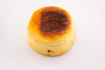 A single, round cheese bun is presented from an overhead perspective on a white plate. 