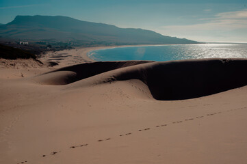 Dunes that lead to Arenosa beach and the mountains distant in the beach of Bologna, Spain