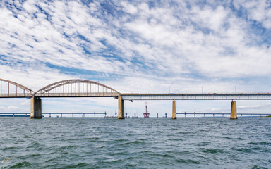Fototapeta premium Old and new bridge under construction, connecting Zealand and Falster over Storstrømmen Strait, Baltic Sea, Denmark
