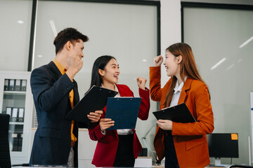 Successful business team, excited young people happy working.