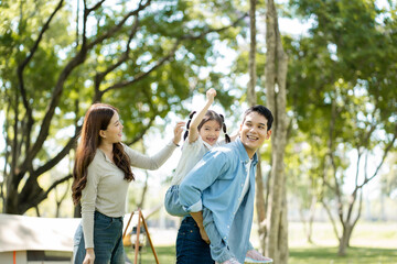 Happy asian family picnic in park, weekend lifestyle outdoors.