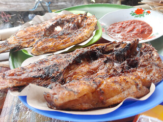 Ikan bakar is an Indonesian grilled fish dish, marinated with spices and often served with sambal. The fish is cooked over an open flame, giving it a smoky flavor.