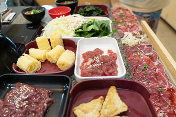 Sliced ​​meat and fresh vegetable ingredients on the shabu dining table