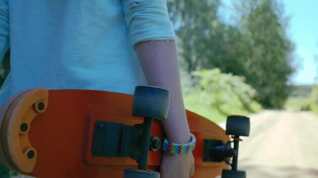 Sunny Summer Skate: Girl Riding a Skateboard Down a Rural Road