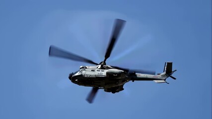 Military helicopter in flight performing during a public display for Armed Forces Day, showcasing aviation and defense power.