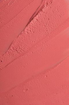 Close-up of pink cosmetic cream texture for background