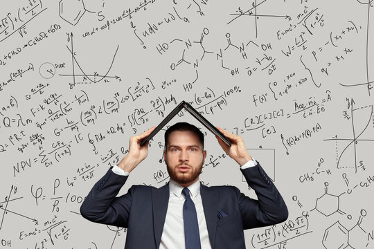Businessman working in stress hiding under his laptop with mathematical equations and graphs vector drawing on the background. Overwhelming, finding solution concept - Powered by Adobe