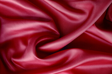 Dark red silk with soft curves and vibrant reflective surface. Suitable for design and wallpaper background