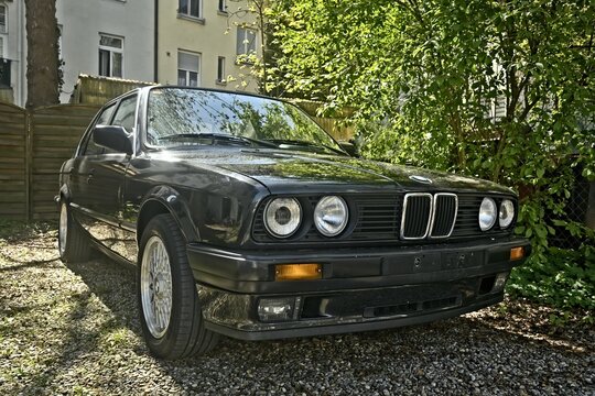 Neu-Ulm, Germany - April, 19, 2025:  BMW E30 classic car parking at the backyard.	