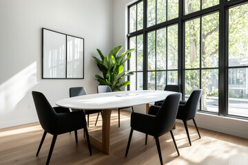 minimalist meeting room design features white oval table surrounded by black chairs, illuminated by natural light from large windows. space is enhanced by green plant, creating calm atmosphere