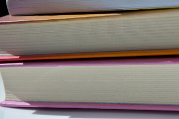 colorful stack hardcover books detailed textures pages natural light modern feel bookstore library reading programs book fairs educational publishing printing high-quality binding work back-to-school