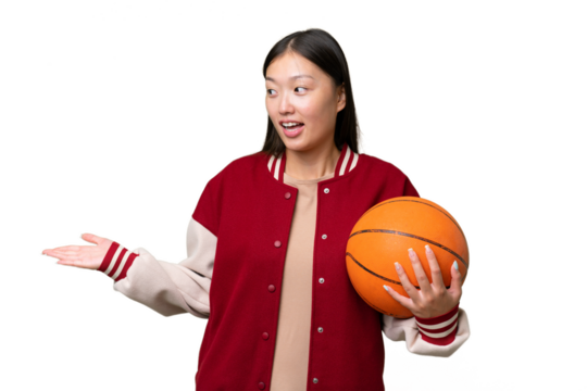 Young basketball player asian woman over isolated background with surprise expression while looking side