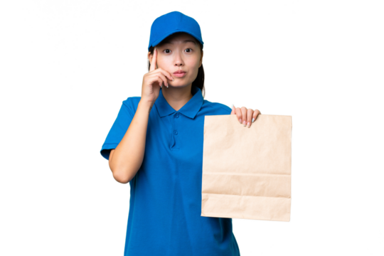 Young Asian woman taking a bag of takeaway food over isolated background thinking an idea