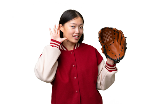 Young asian woman with baseball glove over isolated background listening to something by putting hand on the ear