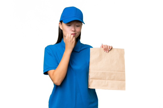 Young Asian woman taking a bag of takeaway food over isolated background having doubts