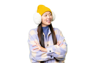 Young Asian woman wearing winter muffs over isolated chroma key background happy and smiling