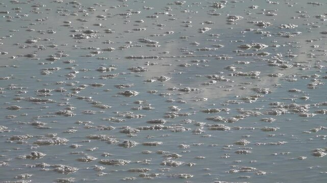 Process of formation of self-setting salt. Salt is deposited at bottom of very salty reservoir, 60 ppm more, on surface there is hypersalted water, rose brine. Sun's rays play in water and crystals