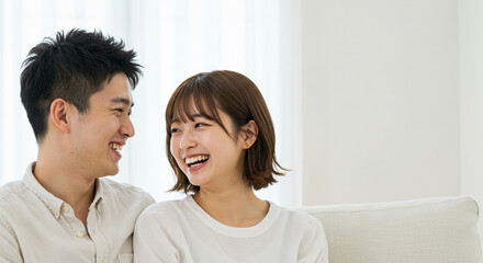 笑顔で寄り添い見つめ合う若い男女のカップル。友達、パートナー、恋人、結婚、新婚イメージ。