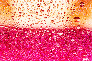 background texture for background bright pink, peach, orange color with shimmers and flowing drops on glass, beautiful bright background with overflows and gradient