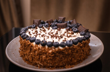 delicious chocolate cake with candles and blueberries for a holiday or birthday.