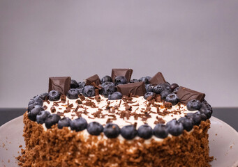 delicious chocolate cake with candles and blueberries for a holiday or birthday.