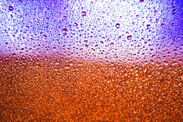 background texture for background of brown and orange color and purple color with shimmering elements and flowing drops on glass, with overflows and bokeh, beautiful bright background with overflows a