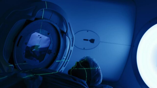 Cancer treatment in a modern medical private clinic or hospital using a linear accelerator. A young male undergoing radiation therapy for cancer. Concept of modern medical technology.