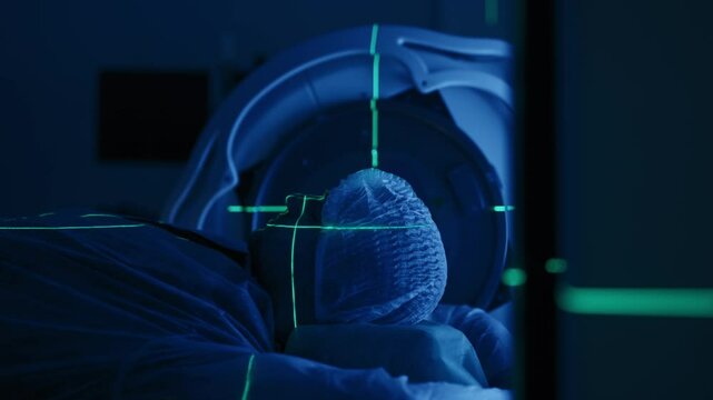 Cancer treatment in a modern medical private clinic or hospital using a linear accelerator. A young male undergoing radiation therapy for cancer. Concept of modern medical technology.