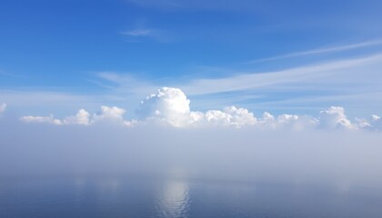 Vast expanse of sky, clouds, and fog over water