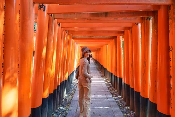 Fotobehang Asian woman enjoying in tunnel of red torii gates lines at Fushimi Inari, Kyoto © Mumemories