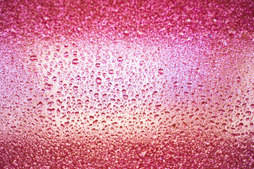background texture for background bright pink color with shimmers and flowing drops on glass, beautiful bright background with overflows