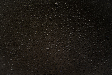 background texture for black background with shimmering elements and flowing drops on glass, with overflows and bokeh, beautiful bright background with overflows and gradient