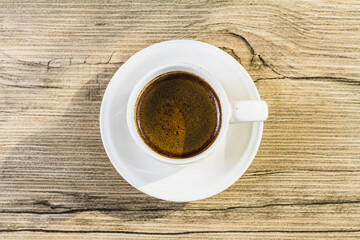 cup of coffee on wooden table
