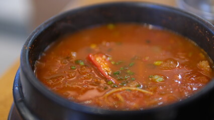 Korean traditional food Kimchi, Kimchi soup in black bowl