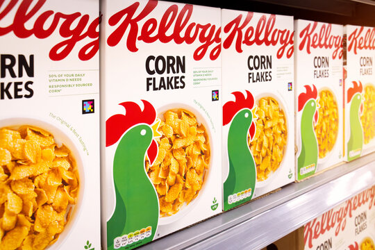 Kellogg's Corn Flakes cereal boxes in stock on retail store shelf. The iconic toasted maize breakfast cereal brand is a classic staple of the US, UK and global diet.